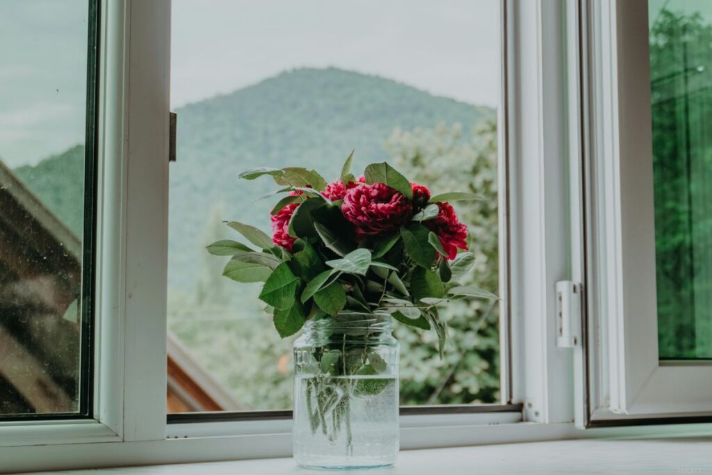 open window with flowers in a vase