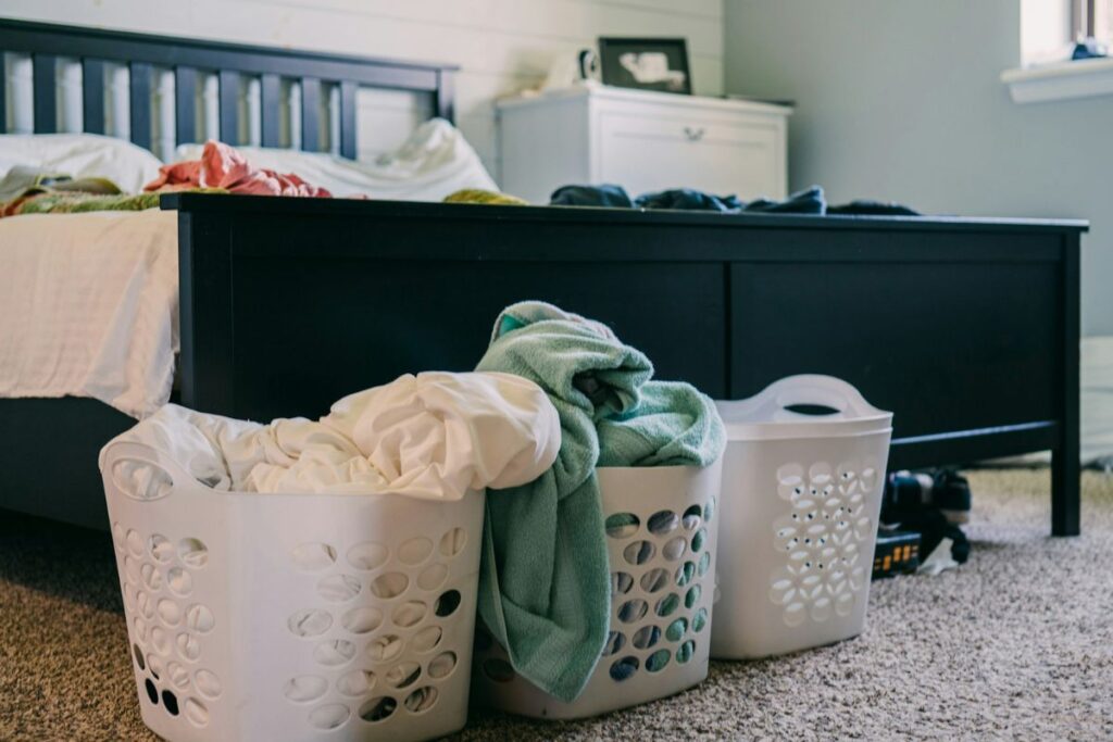 full laundry baskets in a bedroom