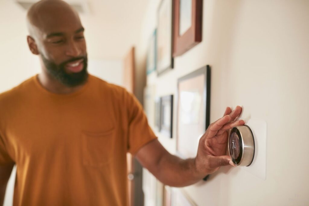 man adjusting temperature